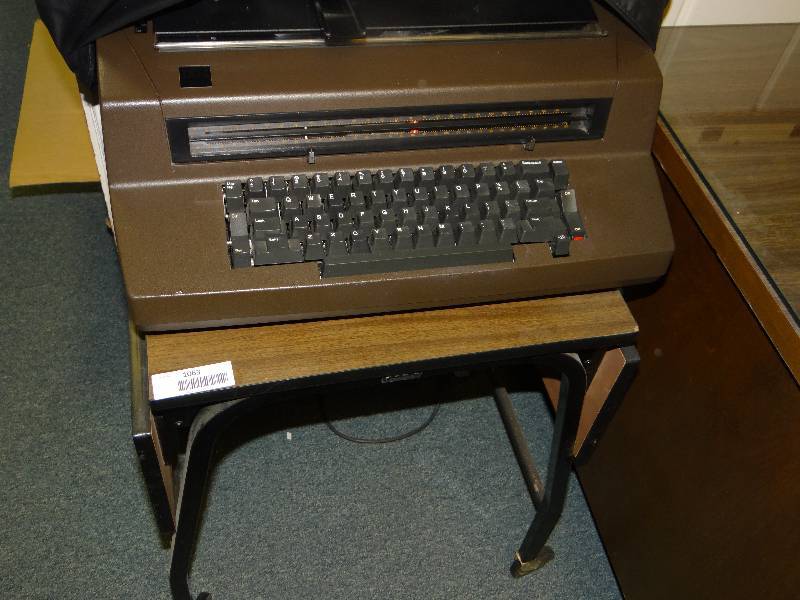 lot 1063 image: Metal Shelf On Wheels W1 BM Electric Typewriter.