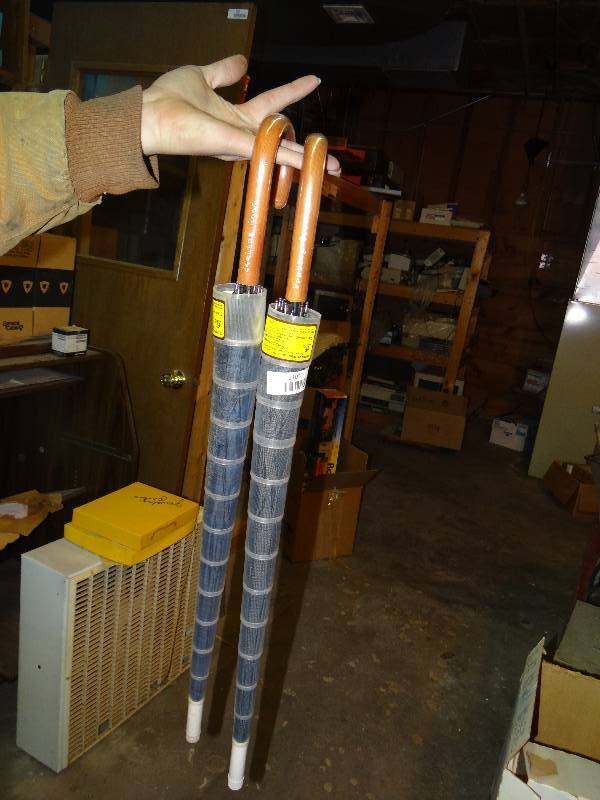 lot 1105 image: Two Feeling Good Umbrellas.