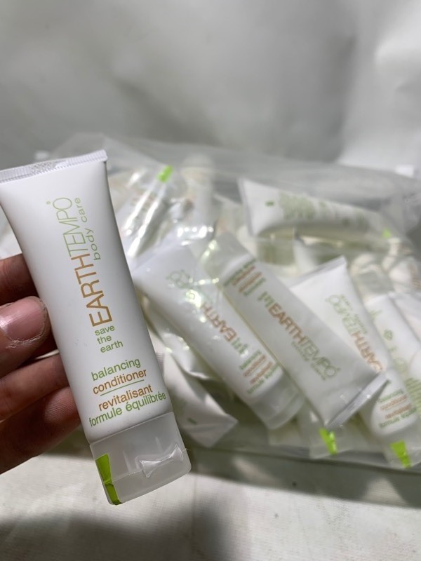 lot 348 image: 1 Giant Bag of 50 EarthTempo Body Care Travel Sized Bottles of Conditioner