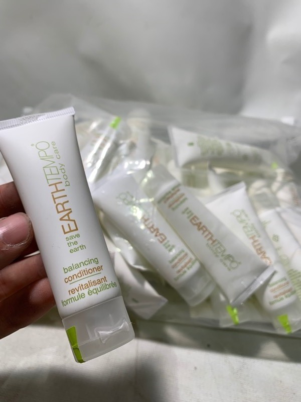 lot 349 image: 1 Giant Bag of 50 EarthTempo Body Care Travel Sized Bottles of Conditioner