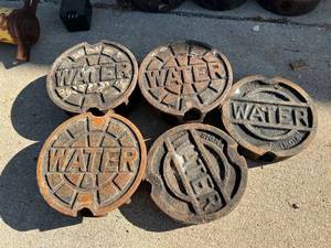 lot 6518 image: 5- Sigma cast iron in ground water utility covers- 3 tall 2- short