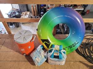 lot 10690 image: Homedepot 5 gallon jug ,peva table cloth, Ozark trial swimming donut