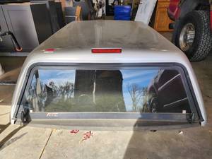 lot 10701 image: ATC Camper Shell Silver Fits 2016 Dodge Ram 6.5 Truck Bed