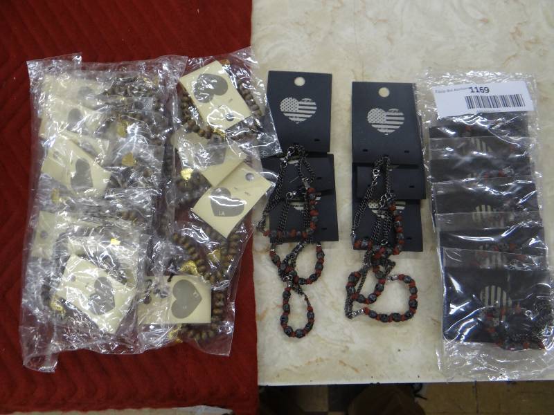 lot 1169 image: Whole sale lot - 16 skullchain bracelets, 14 wood bead & gold charm bracelets - all but 6 are still in packages.