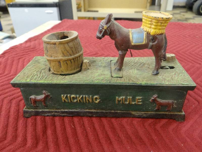 lot 1185 image: Vintage painted iron kicking mule bank - spring action.