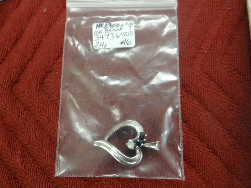 lot 1128 image: 10K white gold heart pendant wmother of pearl stone & black stones.