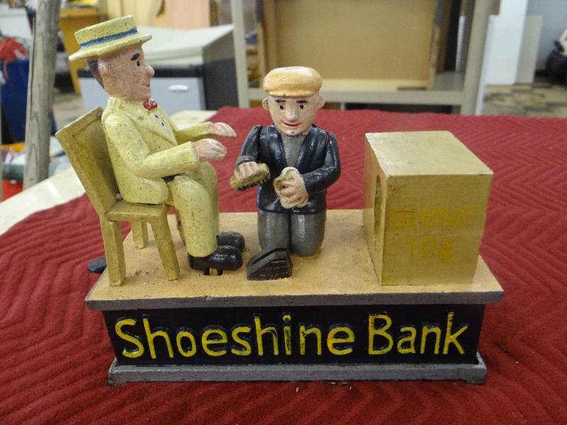 lot 1189 image: Vintage painted iron shoe shine bank - spring action.