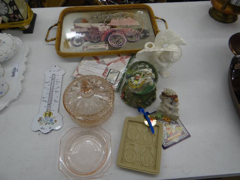 lot 1288 image: Bamboomirrored tray, pink glass candy dish & plate , cherub candle holder, water globe, dreamsicle, french thermometer, cookie press & cloth napkins.