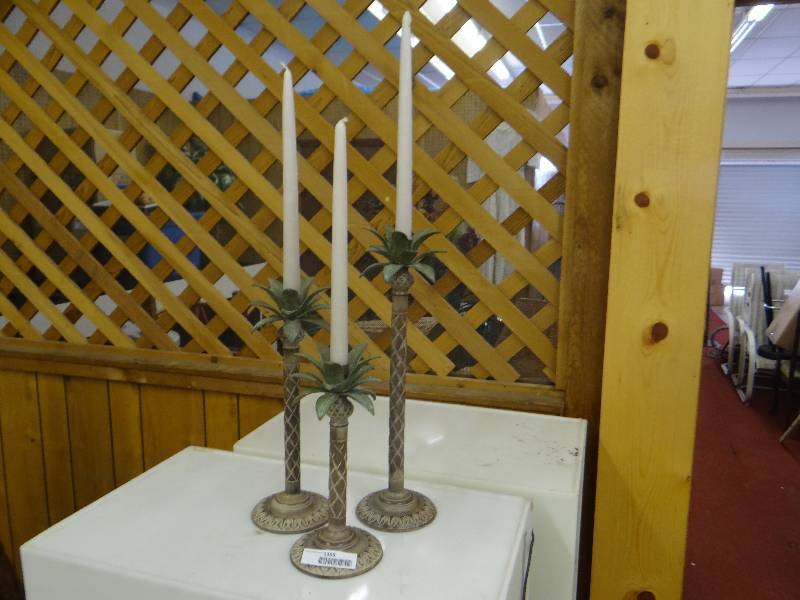 lot 1355 image: Set of 3 metal palm tree candle sticks wtall tapers.