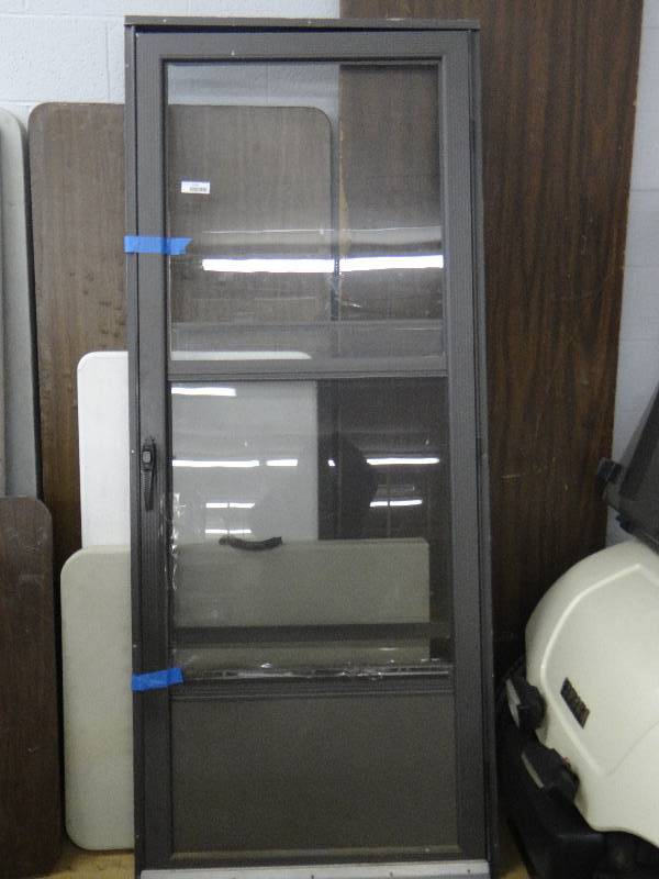 lot 1379 image: Bronze color screen door - 34 X 82 total size.