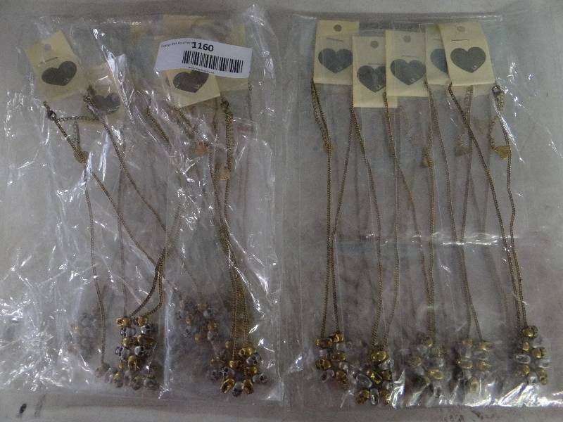 lot 1160 image: Lot of 20 packaged goldsilver skull necklaces - great whole sale lot.