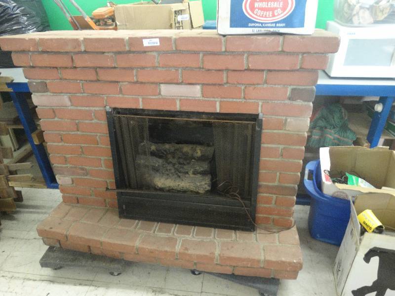 lot 1951 image: Fake brick fireplace set up.