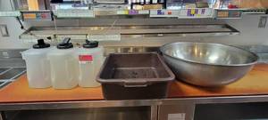 lot 10846 image: 4 Liter Storage Containers W Lids, 20in Stainless Steel Vollrath Mixing Bowl, and a Brown Dish Tub