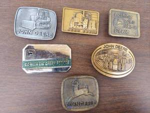 lot 5605 image: 6 John Deere belt buckles