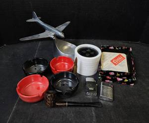 lot 289 image: Zippo Lighters, Pipe, Ashtrays, Coasters, and Metal Airplane Dish