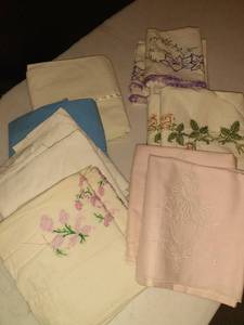 lot 1111 image: Hand embroidered pillow cases. A few are just plain