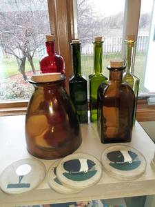 lot 1167 image: Various sized and colored bottles with cork tops and a set of coasters