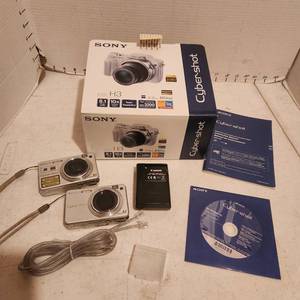 lot 2116 image: 2 Sony Cyber-Shot digital cameras, battery charger and CD