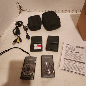 lot 2117 image: 2 Canon Power Shot digital cameras, cases and battery charger