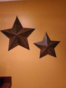 lot 2307 image: Two brown tin star wall decor about 24 and 18 wide and 3 deep