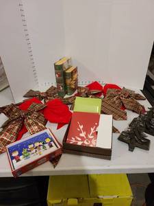 lot 3067 image: Holiday cards, bows, book box decor, stocking hangers, though one is missing the hook.