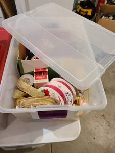lot 3071 image: 66 qt. storage tote with rolls of ribbon