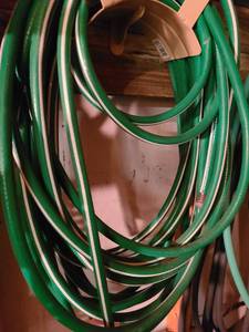 lot 4032 image: Two green garden hoses