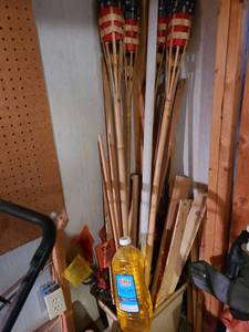 lot 4039 image: Tiki torches, torch fuel and wood in trash can
