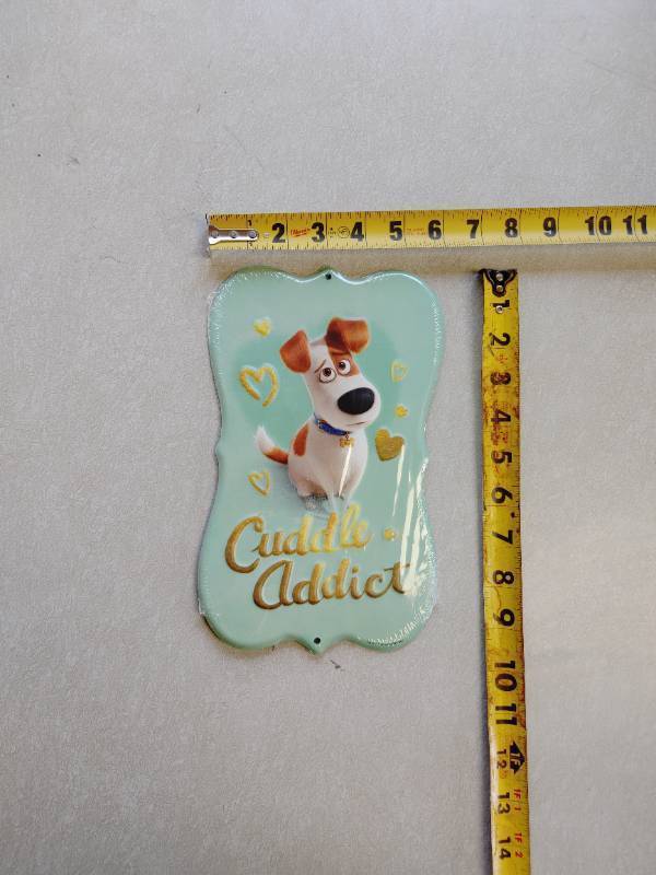 lot 10 image: Cuddle Addict Tin wall sign