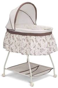 lot 54412 image: Delta Children Deluxe Sweet Beginnings Bedside Bassinet - Portable crib with lights and sounds, falling leaves