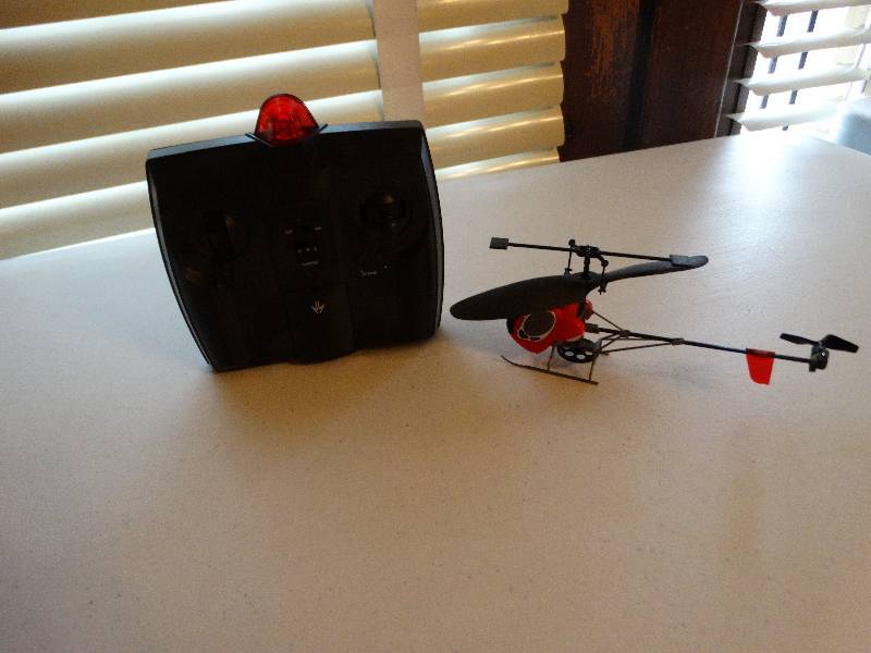 lot 990 image: Little helicopter remote no tested takes 6 AA worked last time in use.