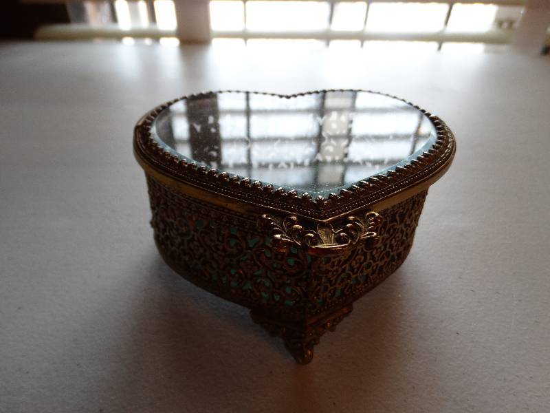 lot 1294 image: Vintage ornate gold matson heart shape trinket box wbeveled glass lid.