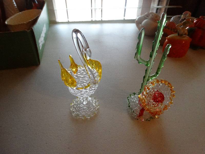 lot 1241 image: Glass swan & Mexican man sitting by cactus.