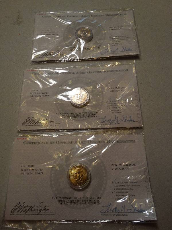 lot 1336 image: Lot of 3 wgloves Washington gold dollars never circulated.