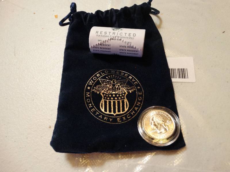lot 1343 image: State of Kansas roll of quarters & one in case & pouch never circulated.