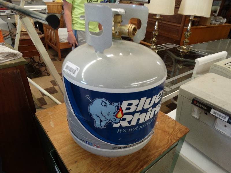 lot 379 image: Blue rhino near full propane tank.