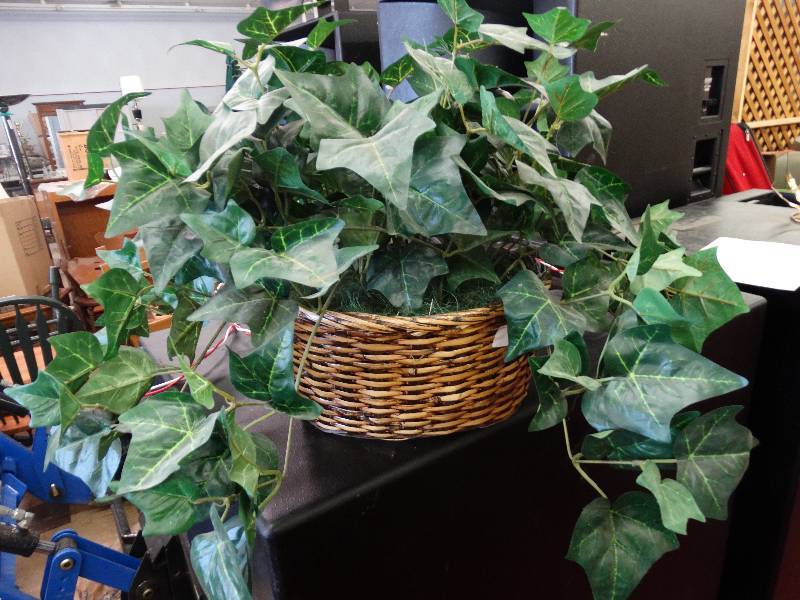 lot 881 image: Fake plant in wicker pot.