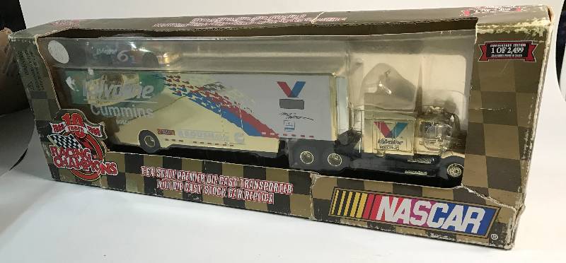 lot 3225 image: NASCAR 10 Years Racing Champions 164 Scale Transporter with Die Cast Stock Car on Top