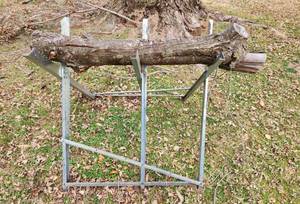 lot 3077 image: Saw Horse Wood Log Holder and 2 Piles of Firewood (located behind the house)