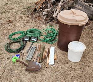 lot 3083 image: Rubbermaid Trash Can, Hoses, Solar Lights, Galvanized Feeder and Tools that need new handles