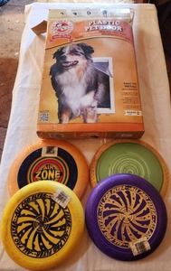 lot 6029 image: Plastic Pet Door Extra Large Flap Size 10 12 x 15 and Frisbees