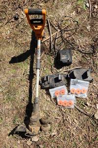 lot 2051 image: WORKS TRIMMER WITH BATTERY, CHARGER, WALL MOUNT and SPOOLS