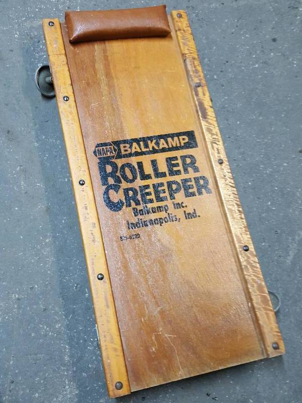 lot 7607 image: For you guys with the cool garage, this old Real Wood creeper with all 4 swivel casters