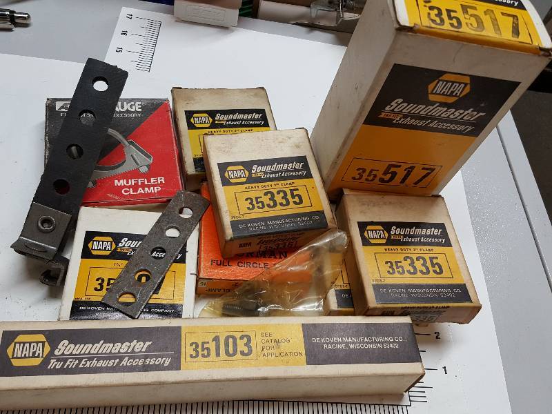 lot 7617 image: Box of new Exhaust clamps and hangers.  Start your own muffler shop