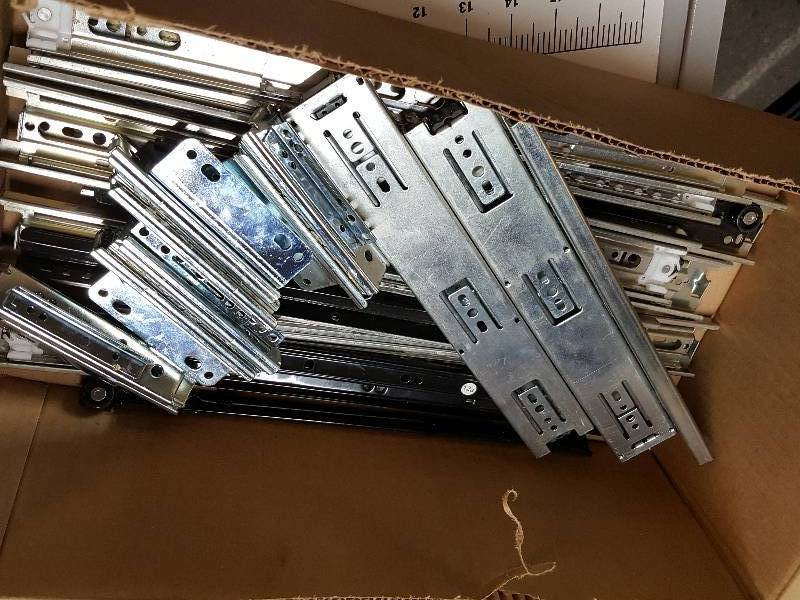 lot 7618 image: Big and heavy box of assorted drawer roller bearing slides.  This is worth looking at
