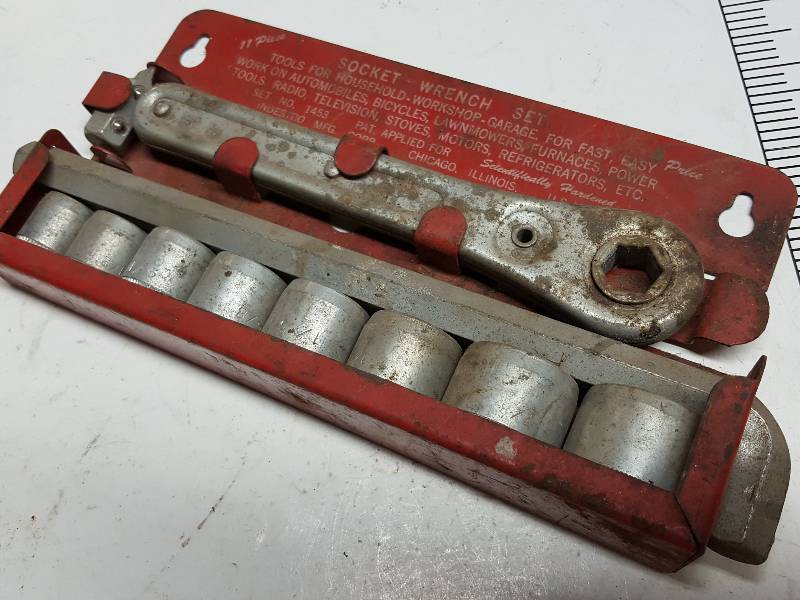 lot 7622 image: Probably used by Noah on the arc is this antique ratchet and socket set made to hang on the wall.
