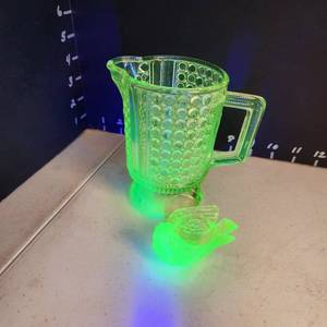lot 1010 image: Uranium glass creamer and candleholder