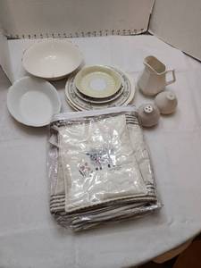 lot 1176 image: Pig Ridge apron and matching potholder, s & p shakers, creamer, serving bowls, plates