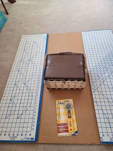 lot 3313 image: Dritz folding cutting board, sewing basket, rotary cutter
