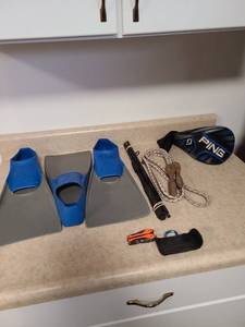 lot 4306 image: Three Tritan flippers size 9-10, Shakespeare Alpha rod, jump rope, Cabelas multi-tool